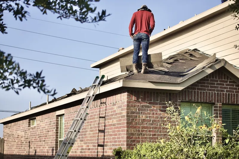 Professional roofer working on a residential roof in Southmont